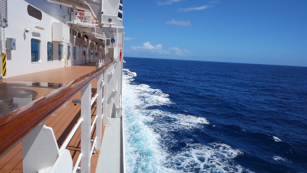 our-services-2 Explore the serene ocean view from a cruise ship deck on a sunny day, ideal for vacation enthusiasts.